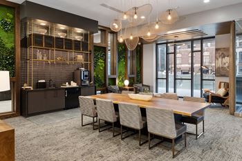 A dining room with a wooden table and chairs